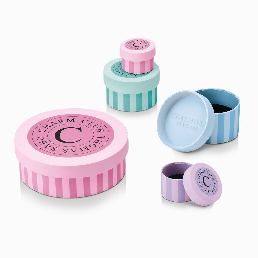 Four pastel striped round jewellery boxes by THOMAS SABO Charm Club in pink, mint, blue, and lilac.