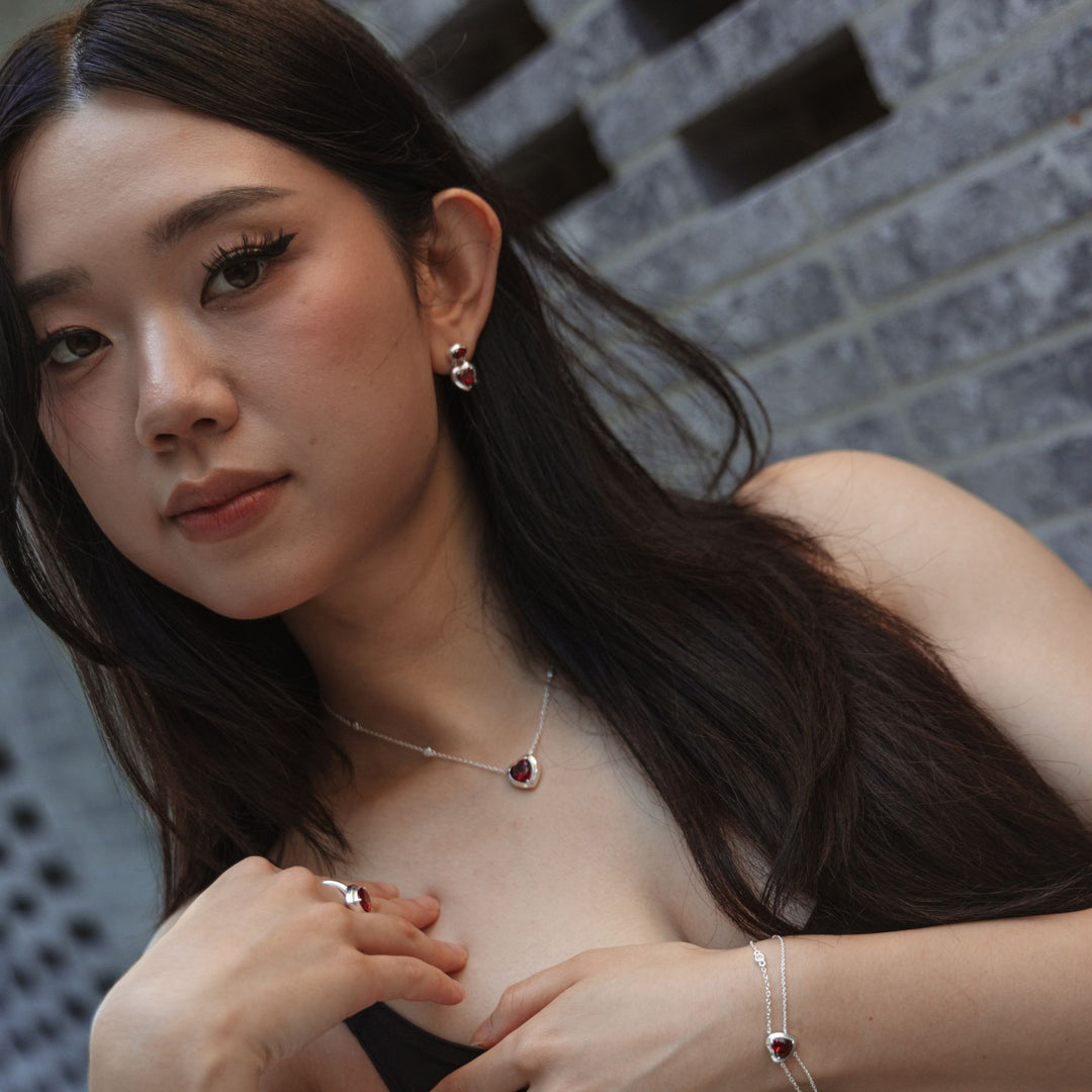 Model wearing THOMAS SABO silver heart jewellery with red stone