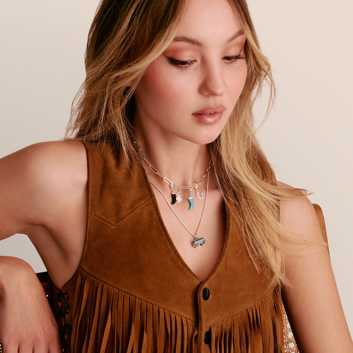 Model wearing THOMAS SABO Charm Club necklace with charms and a VW Bus on chain