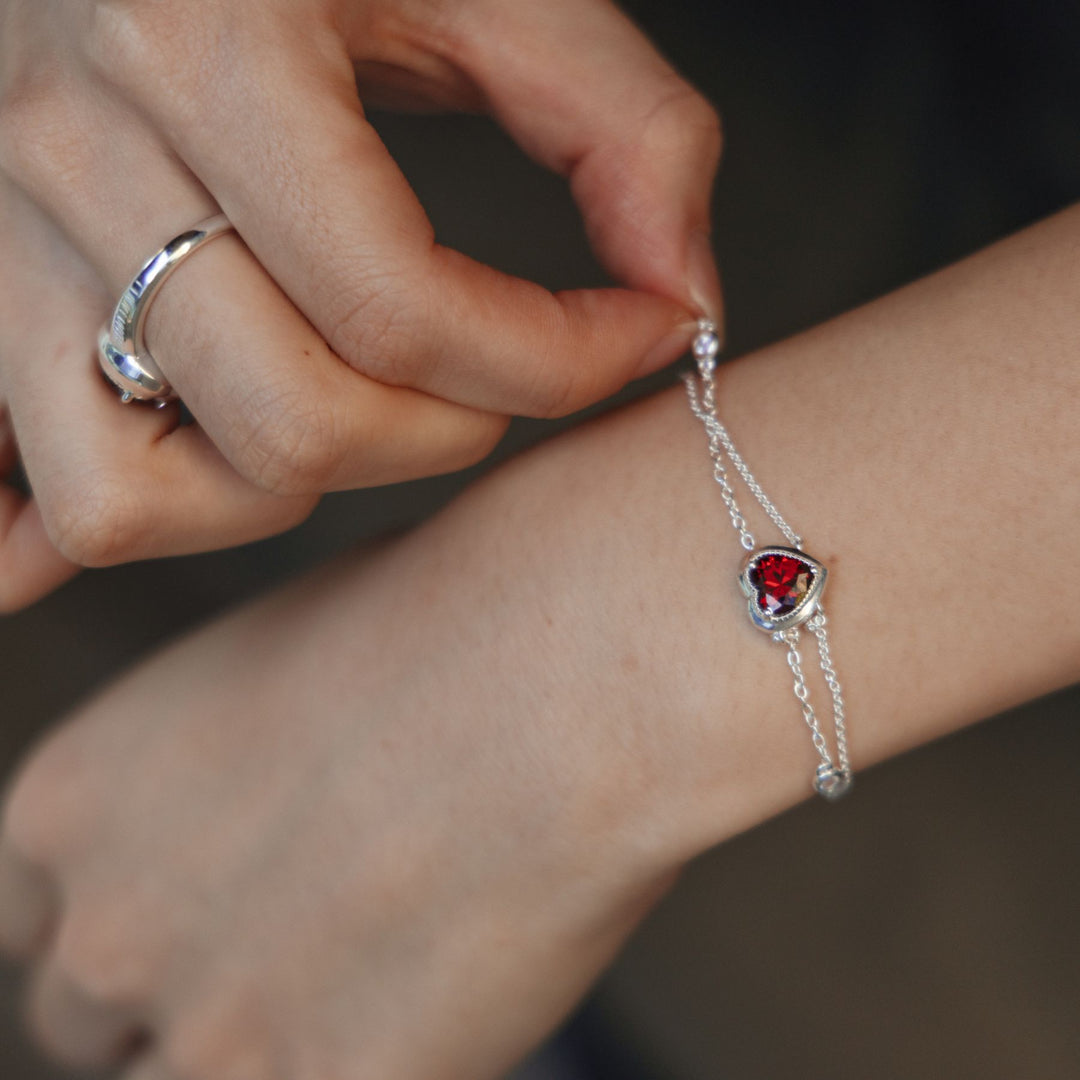 Model wearing THOMAS SABO silver heart jewellery with red stone