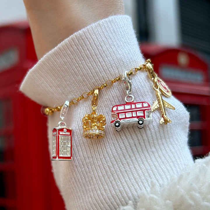 Gold-plated charm bracelet featuring colourful enamel charms: camera, cactus, heart, sunglasses, flip-flop, ice lolly, and palm tree.