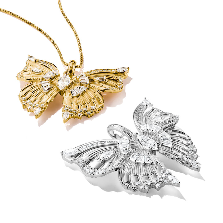 Gold and silver butterfly-shaped diamond pendants on a white background