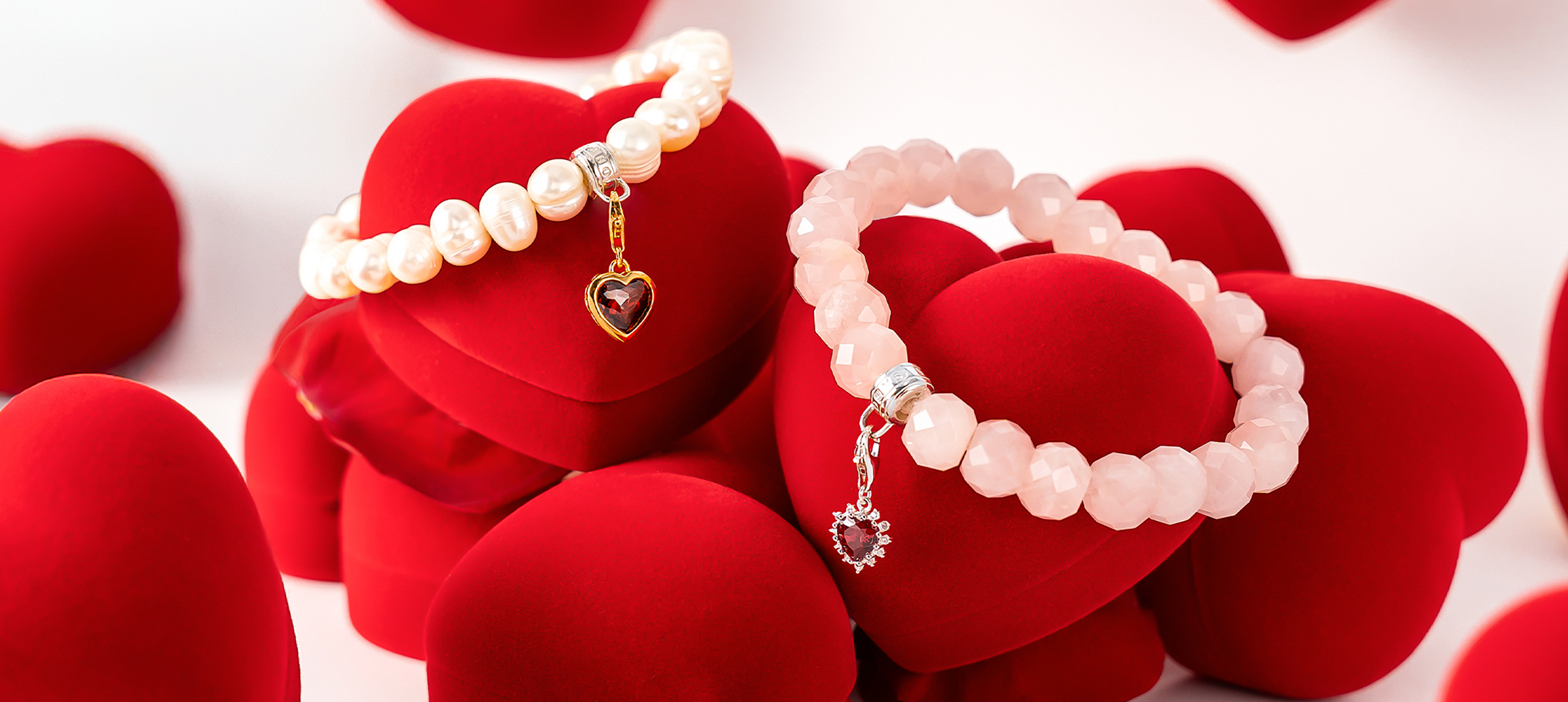 Two hands clasped together wearing THOMAS SABO yellow gold and sterling silver rings, bracelet, and crown pendant necklace; "Together" campaign.